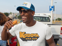 t-shirt-mockup-of-a-man-with-a-trucker-hat-eating-at-a-tailgate-party-29893.webp